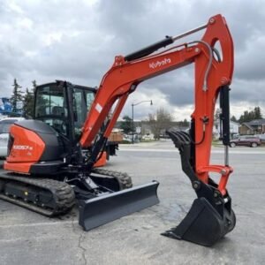 2026 Kubota KX057-5 includes heat, A/C, angle blade, 2X AUX hydraulics, coupler, hydraulic thumb, dig bucket — primary view